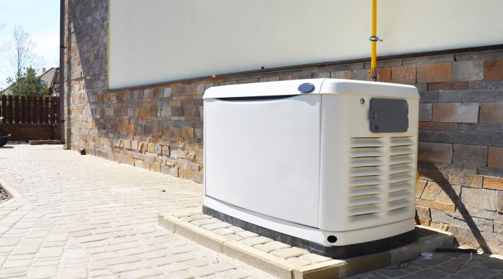 A white residential backup generator installed outside a house, providing reliable power during outages.